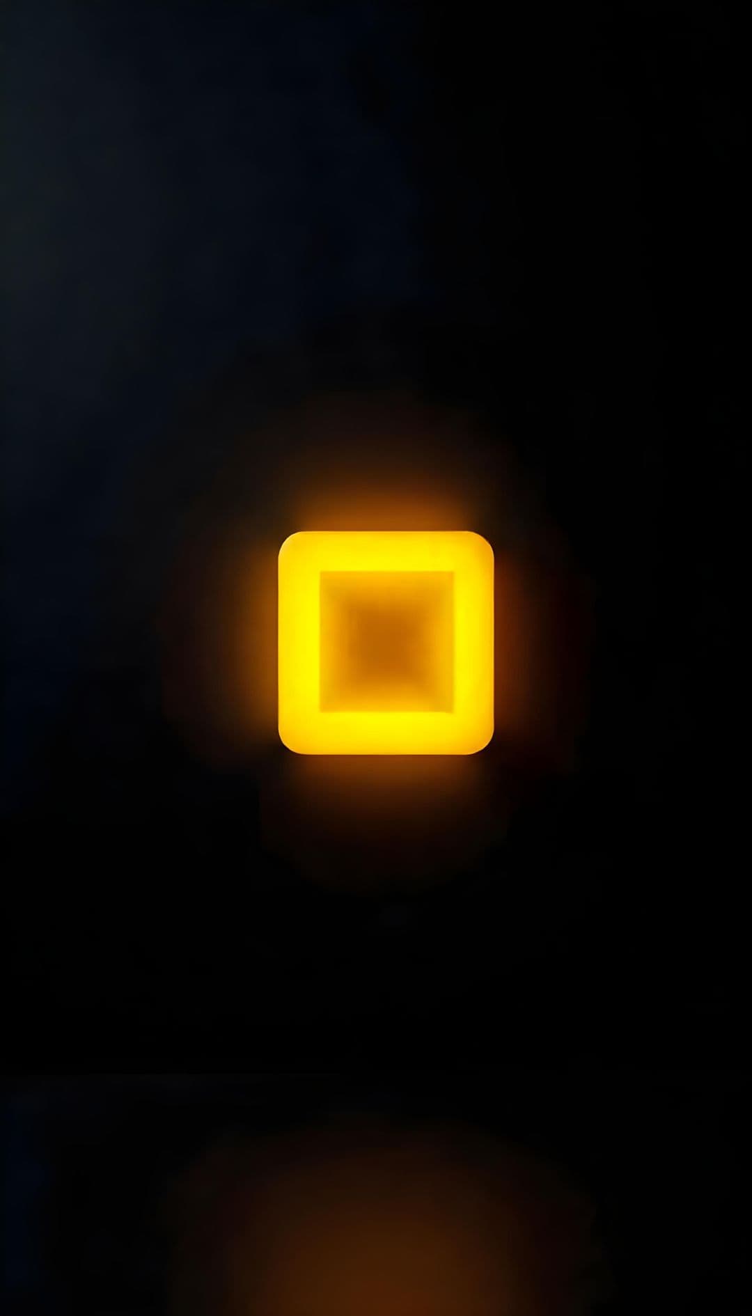A glowing yellow square art piece on a black background.