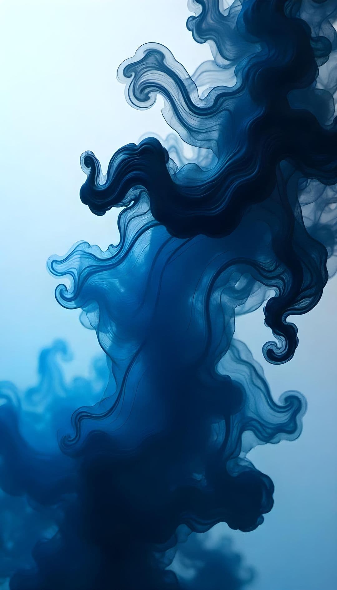 Swirling dark blue ink in a light, translucent space