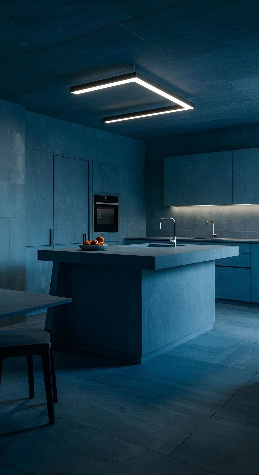 A modern kitchen with cool blue lighting, a central island, and geometric light fixture.